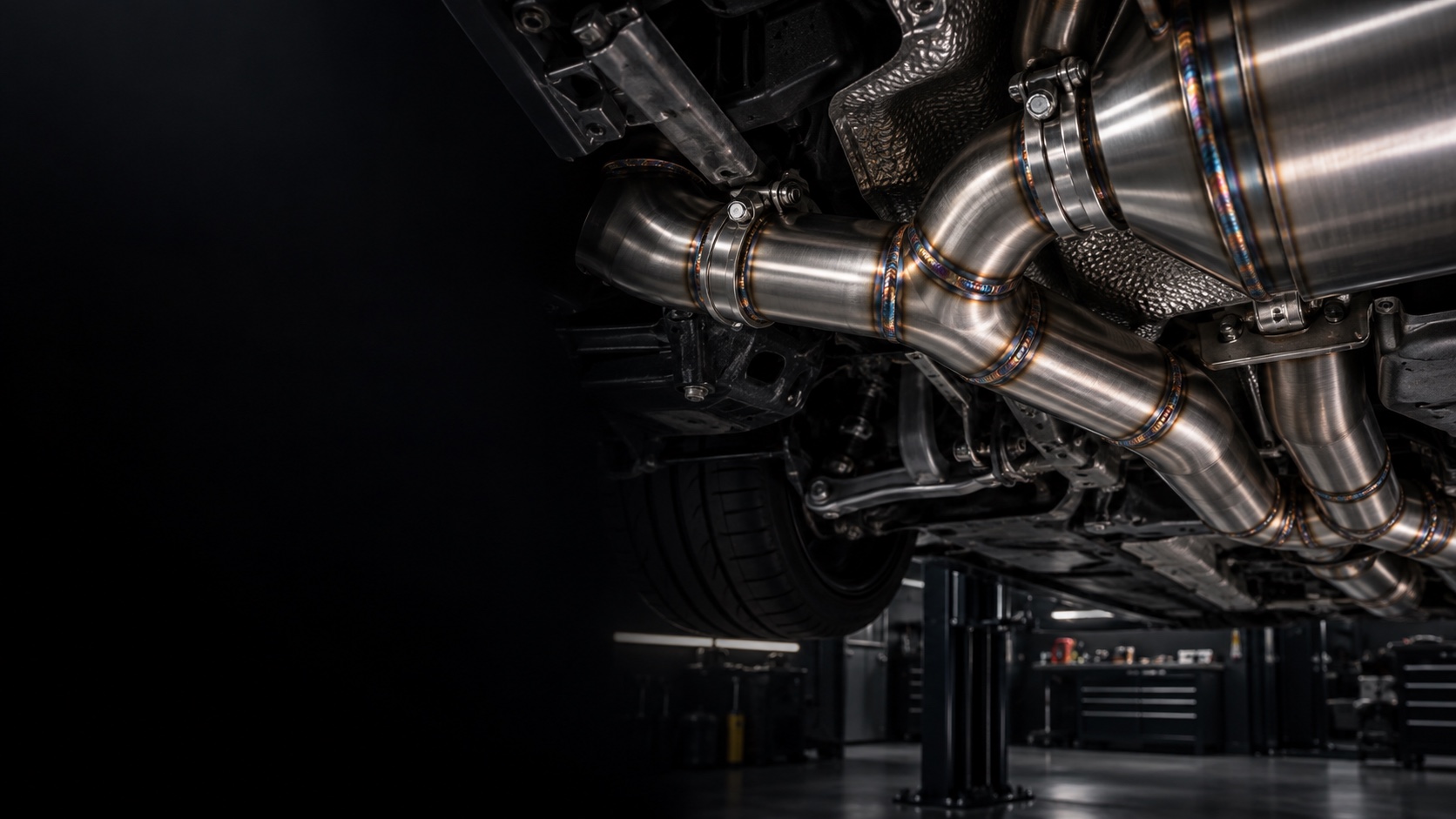 Precision stainless exhaust fabrication beneath a performance car